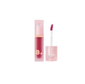 Pink lip tint with applicator and packaging on a white background