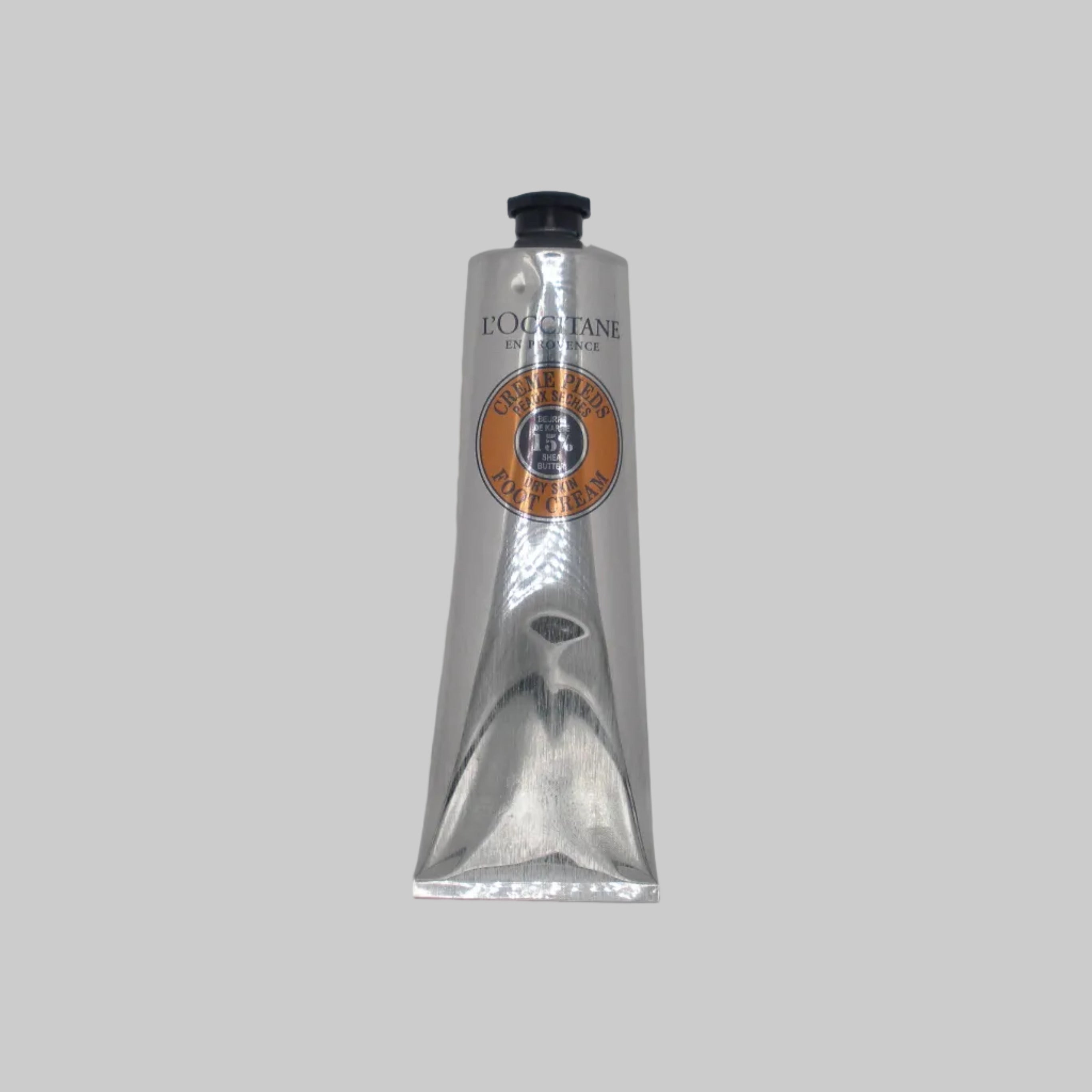 Silver tube with a logo on a gray background