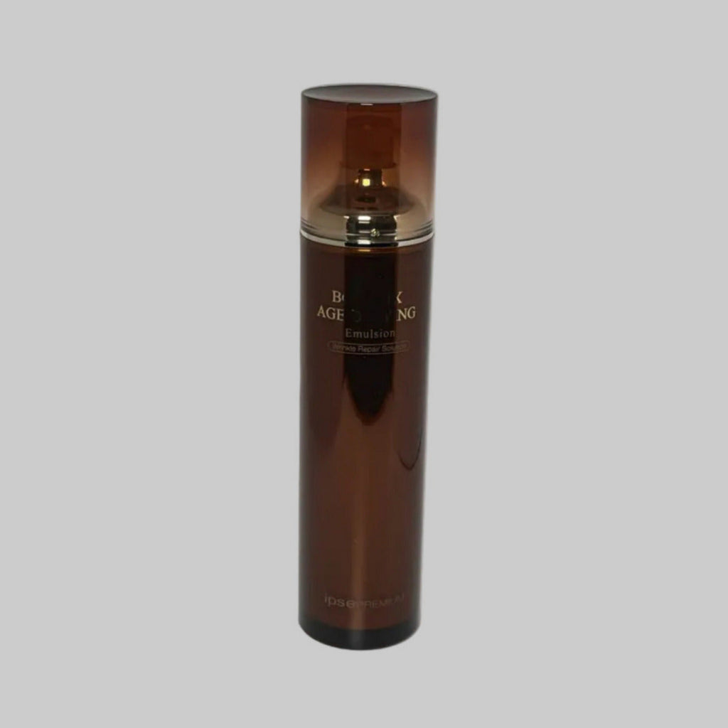 Brown skincare bottle with gold cap on a gray background