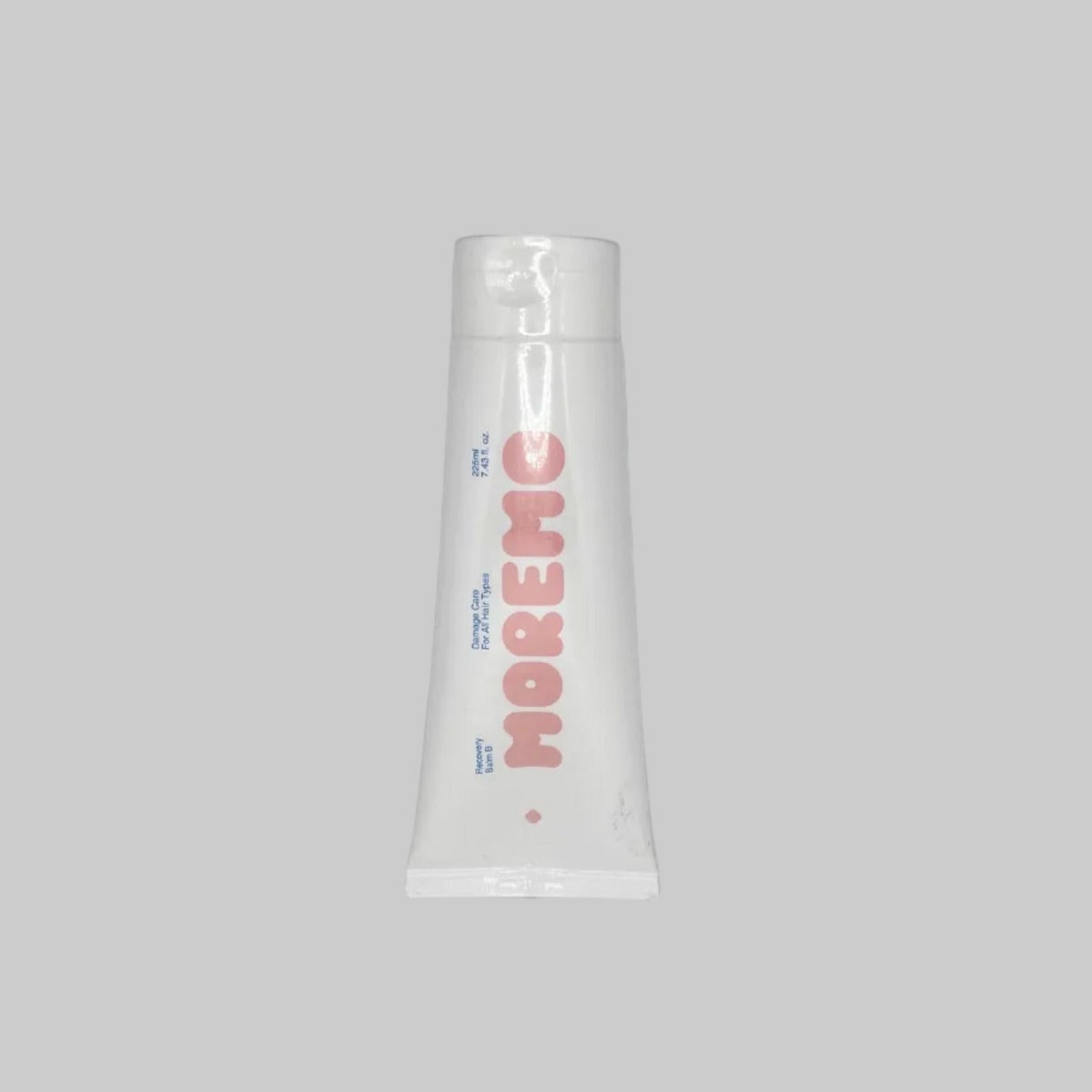 Tube of 'MOREMO' hair treatment on a light gray background